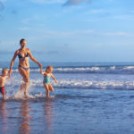 Mom with two kids on the beach